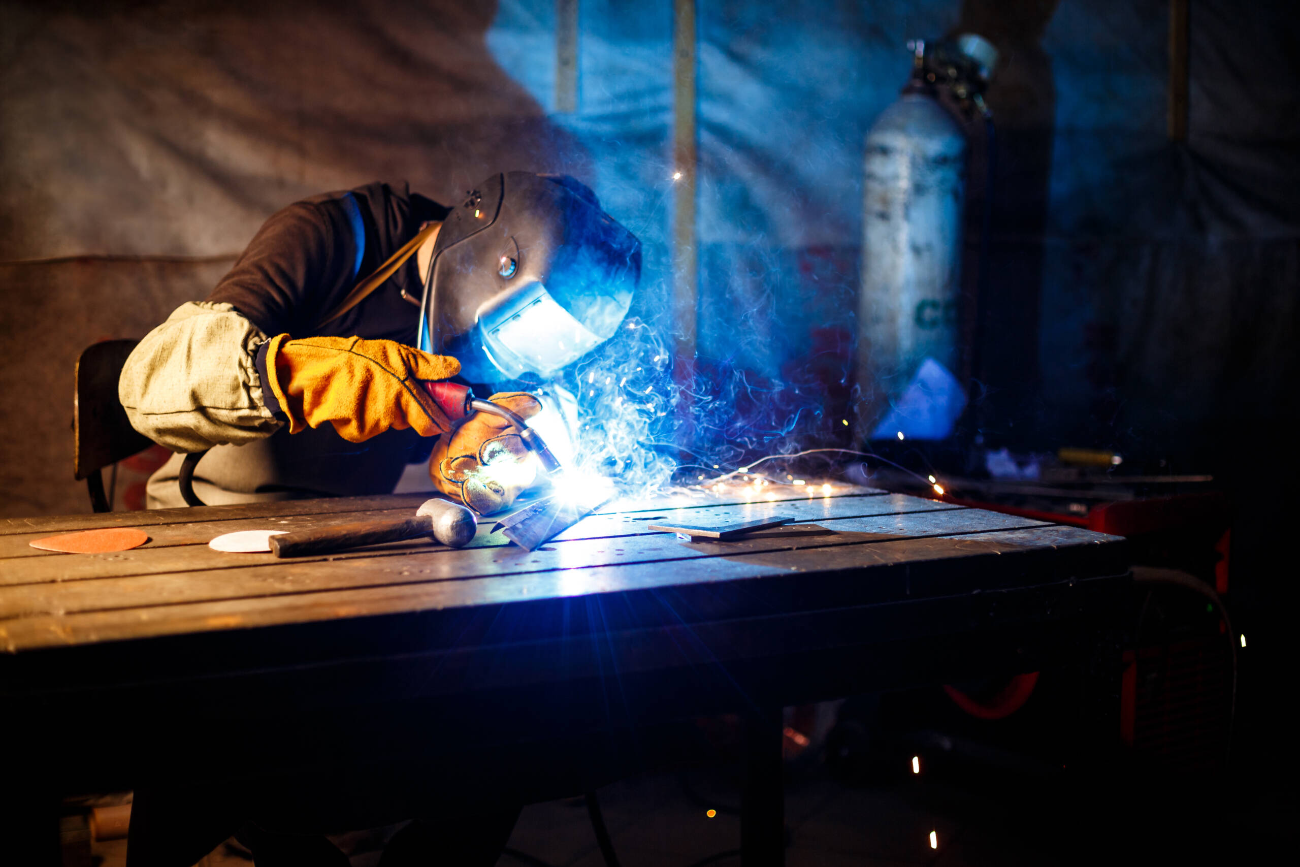 Worker cutting metal with plasma equipment. on plant